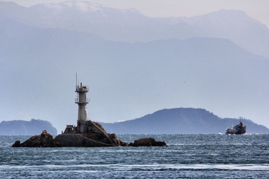 Oshima Island lighthouse and snowy mountians