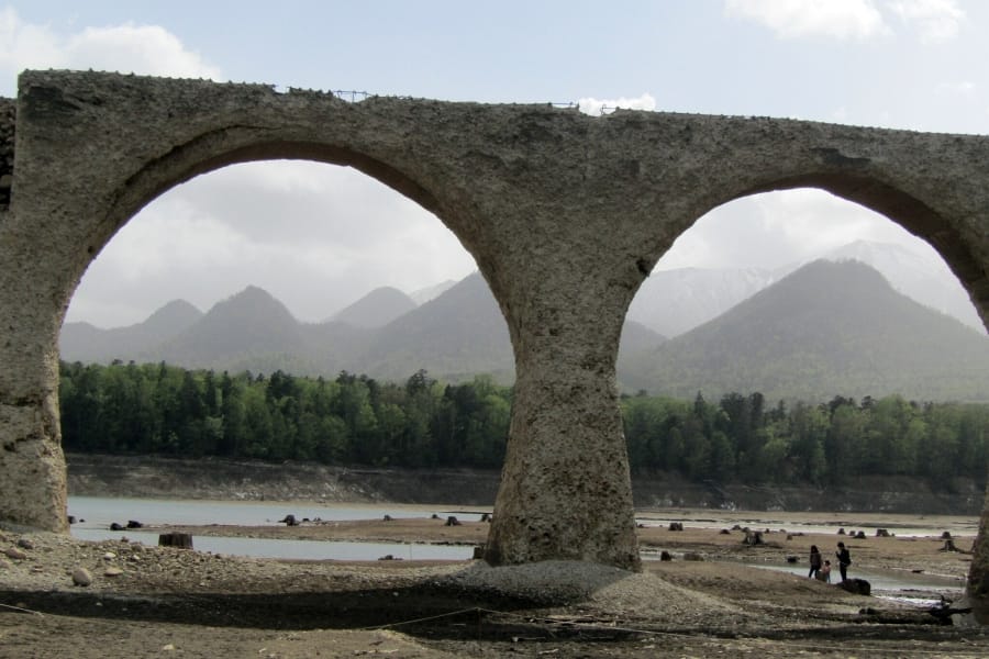 Taushubetsu River Bridge with mountains